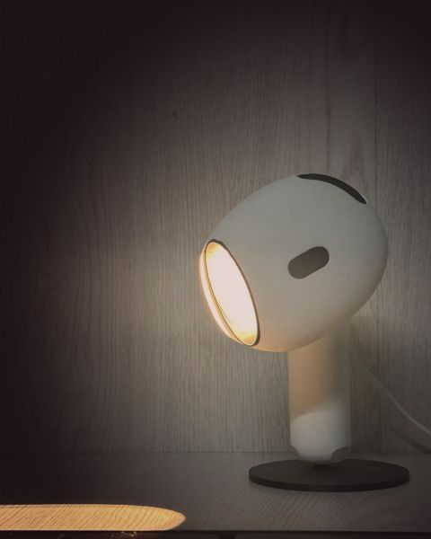 Warm light from the lamp falling on the shelf