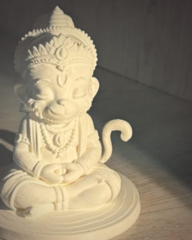 Close-up of the crown and smiling face on a 3D printed Hanuman idol